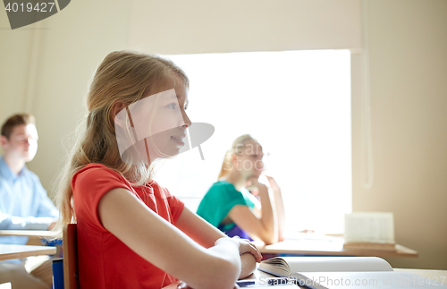 Image of happy student girl at school lesson