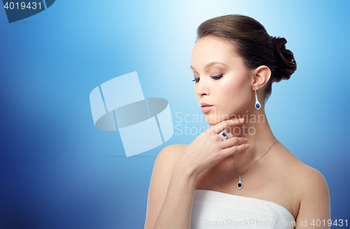 Image of beautiful woman with earring, ring and pendant