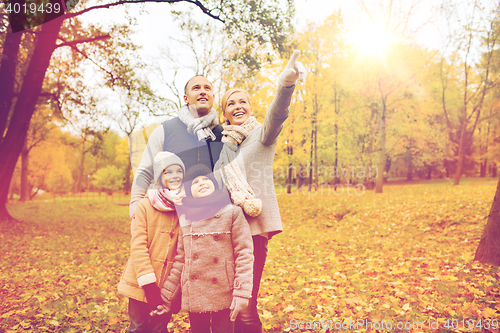 Image of happy family in autumn park