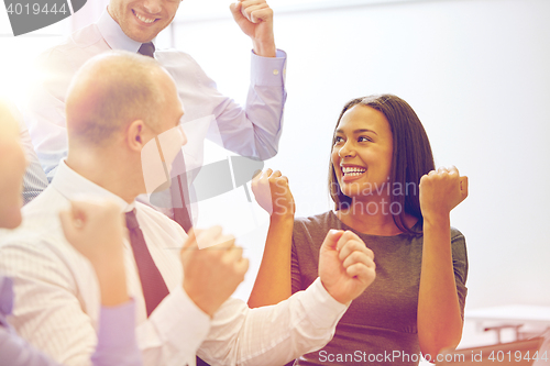 Image of smiling business people meeting in office