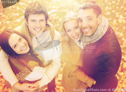 Image of group of friends having fun in autumn park