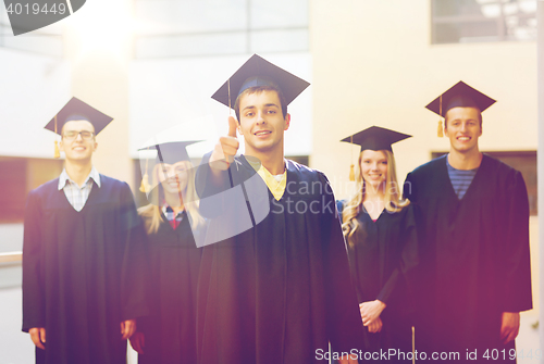 Image of group of smiling students in mortarboards