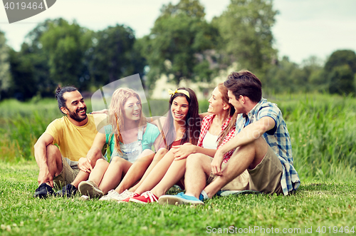 Image of group of smiling friends talking outdoors