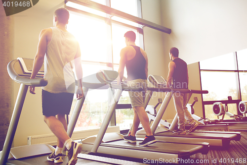 Image of men exercising on treadmill in gym