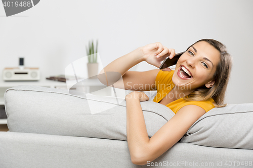 Image of Young woman talking at phone