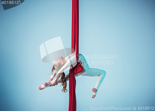 Image of Graceful gymnast performing aerial exercise