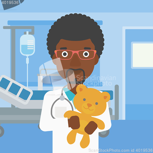 Image of Pediatrician doctor holding teddy bear.