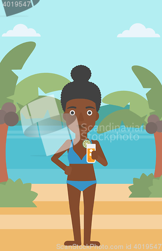 Image of Woman with cocktail on the beach.
