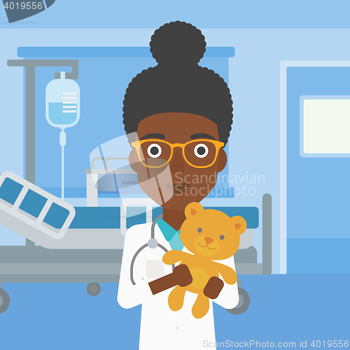 Image of Pediatrician doctor holding teddy bear.