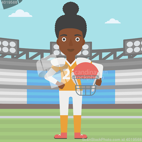 Image of Rugby player with ball and helmet in hands.
