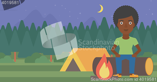 Image of Woman sitting on log in the camping.