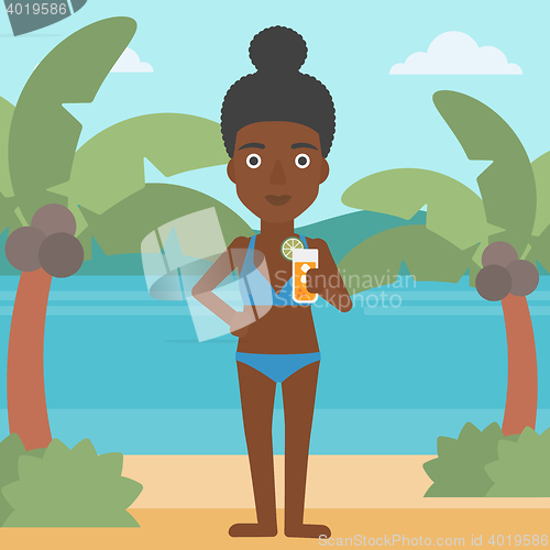 Image of Woman with cocktail on the beach.