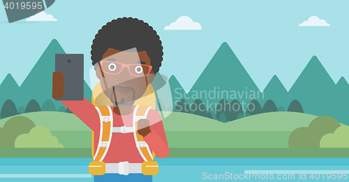 Image of Man with backpack making selfie.