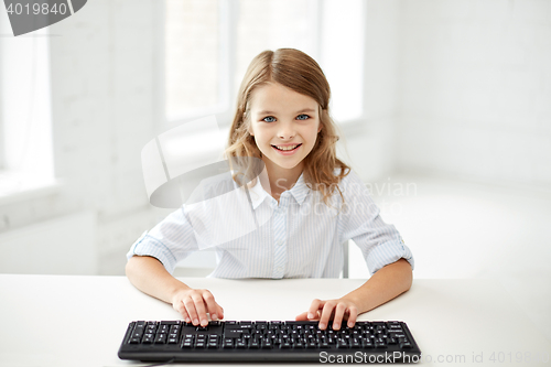 Image of smiling girl with keyboard at school