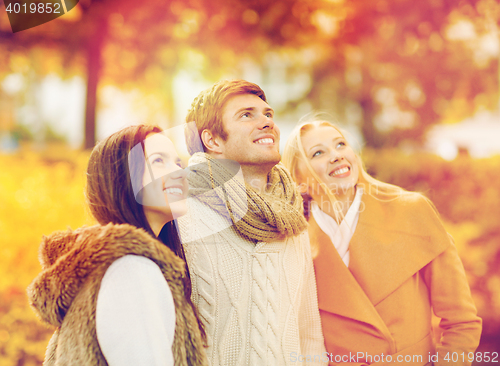 Image of group of friends having fun in autumn park