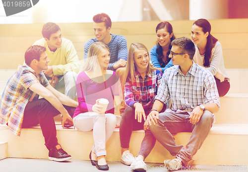 Image of group of smiling students with paper coffee cups