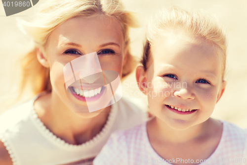 Image of happy mother and little daughter on summer beach