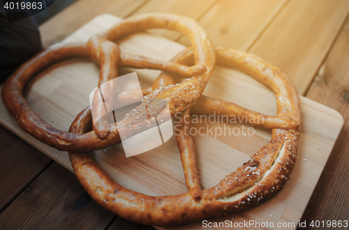 Image of close up of two pretzels on wooden table