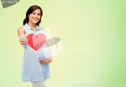 Image of happy pregnant woman with red heart touching belly