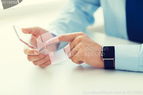 Image of close up of hands with smart phone and watch