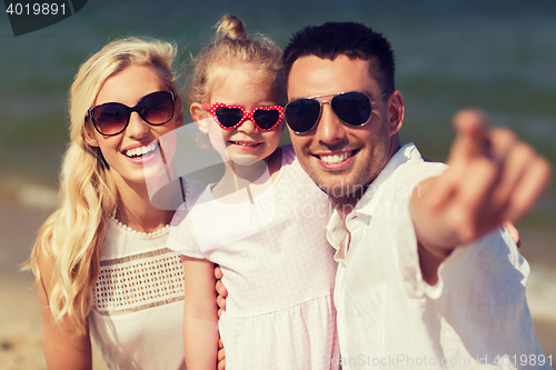 Image of happy family in sunglasses on summer beach