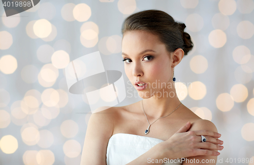 Image of beautiful woman with earring, ring and pendant