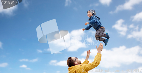 Image of father with son playing and having fun outdoors