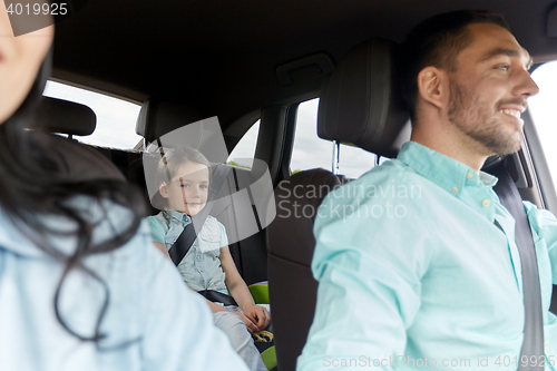 Image of happy family with little child driving in car