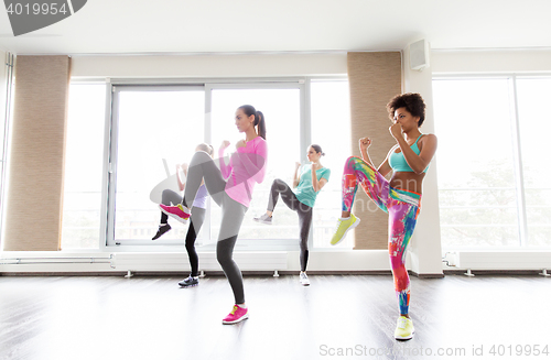 Image of group of women working out fighting stance in gym