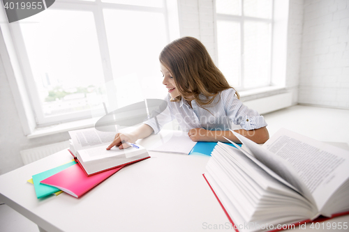 Image of happy smiling school girl with books and notebook