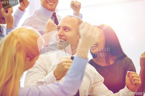 Image of smiling business people meeting in office