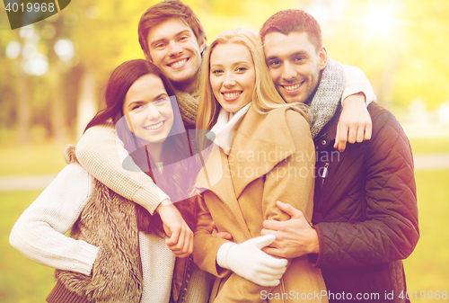 Image of group of friends having fun in autumn park