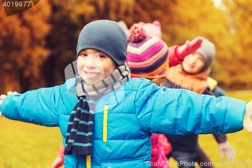 Image of group of happy children having fun in autumn park