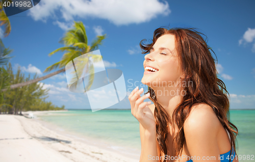 Image of happy beautiful woman on tropical beach