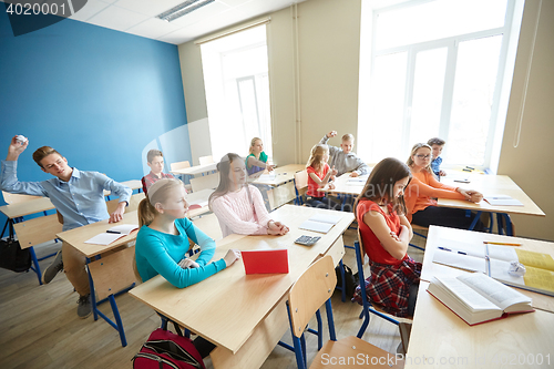 Image of students gossiping behind classmate back at school