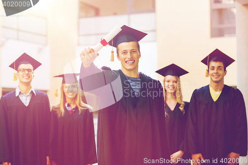 Image of group of smiling students in mortarboards