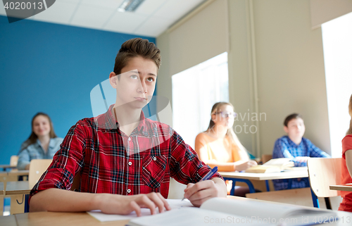 Image of group of students with books at school lesson