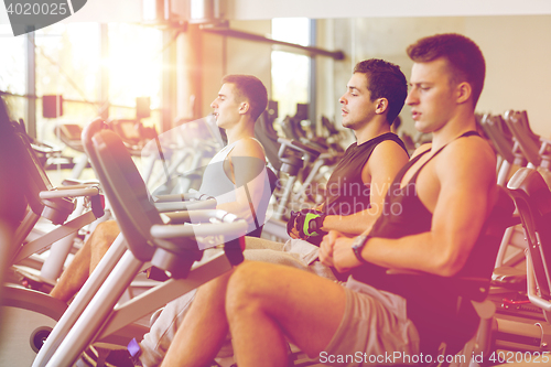 Image of men working out on exercise bike in gym