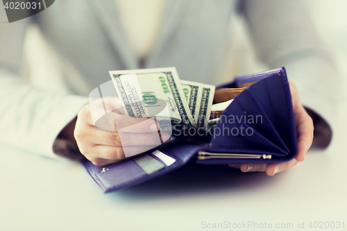 Image of close up of woman hands with wallet and money