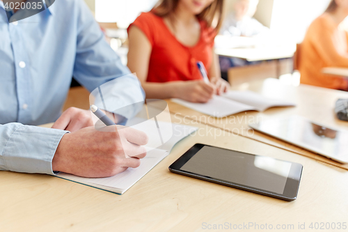 Image of close up of students tablet pc writing at school