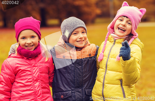 Image of group of happy children hugging in autumn park