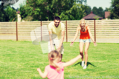 Image of happy family playing outdoors