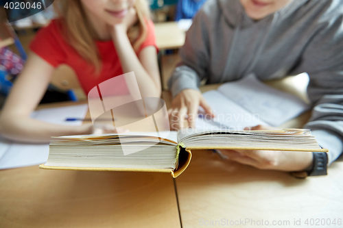 Image of high school students reading book and learning