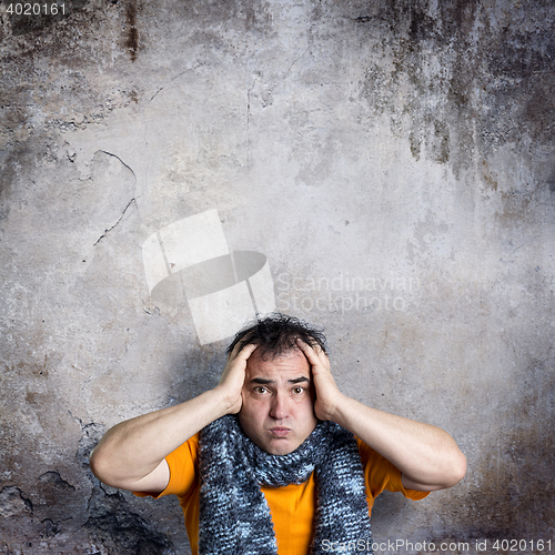Image of Sulky Man Clasping His Head With Both Hands