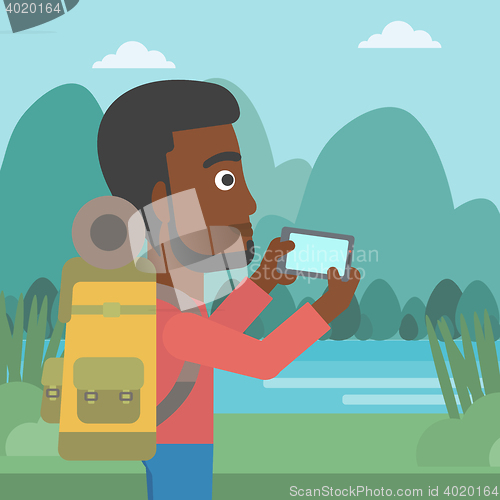 Image of Man with backpack taking photo.