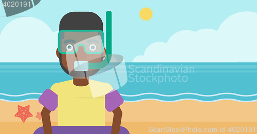 Image of Man with snorkeling equipment on the beach.