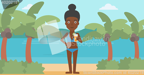 Image of Woman with cocktail on the beach.