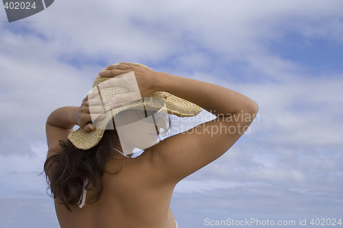 Image of woman holding the hat