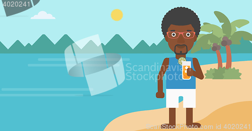 Image of Man with cocktail on the beach.
