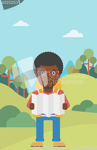 Image of Traveler with backpack looking at map.